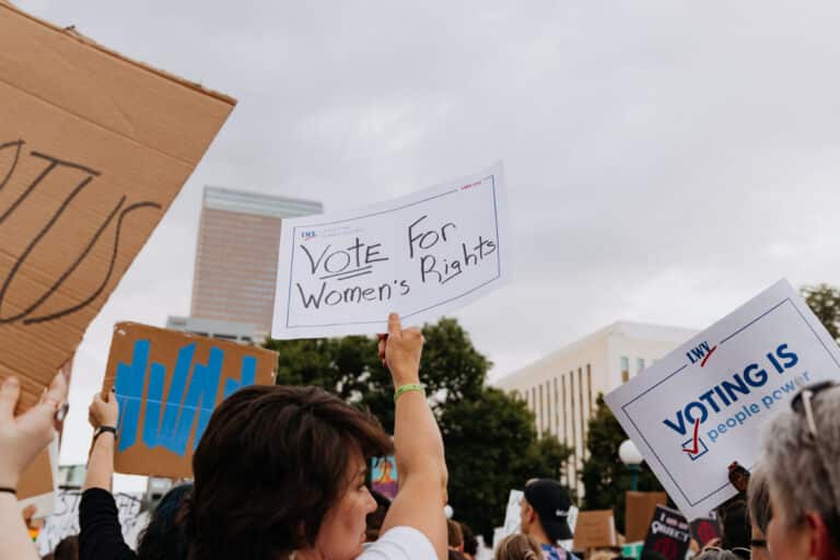 rally/protest, woman holds up sign that reads "Vote for Women's Rights"