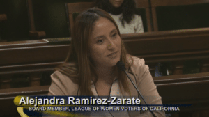 Alejandra (LWVC Board Member) sitting at microphone testifying to the Assembly.