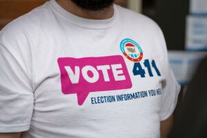 someone wearing a Vote411 Tshirt and NVRD sticker