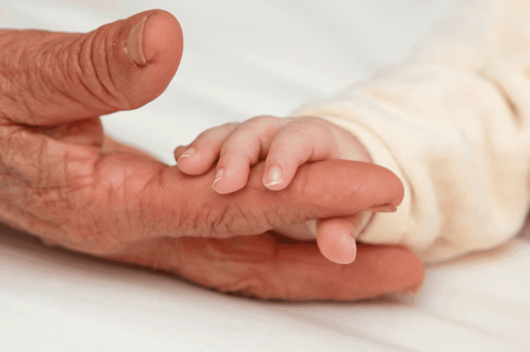 Legacy Planning page (featured) older adult holds baby hand